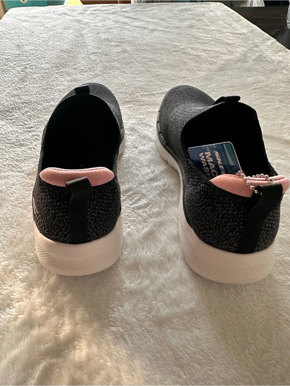Skechers Women’s Black Glimmer Slip-On Sneakers with Pink Lining
